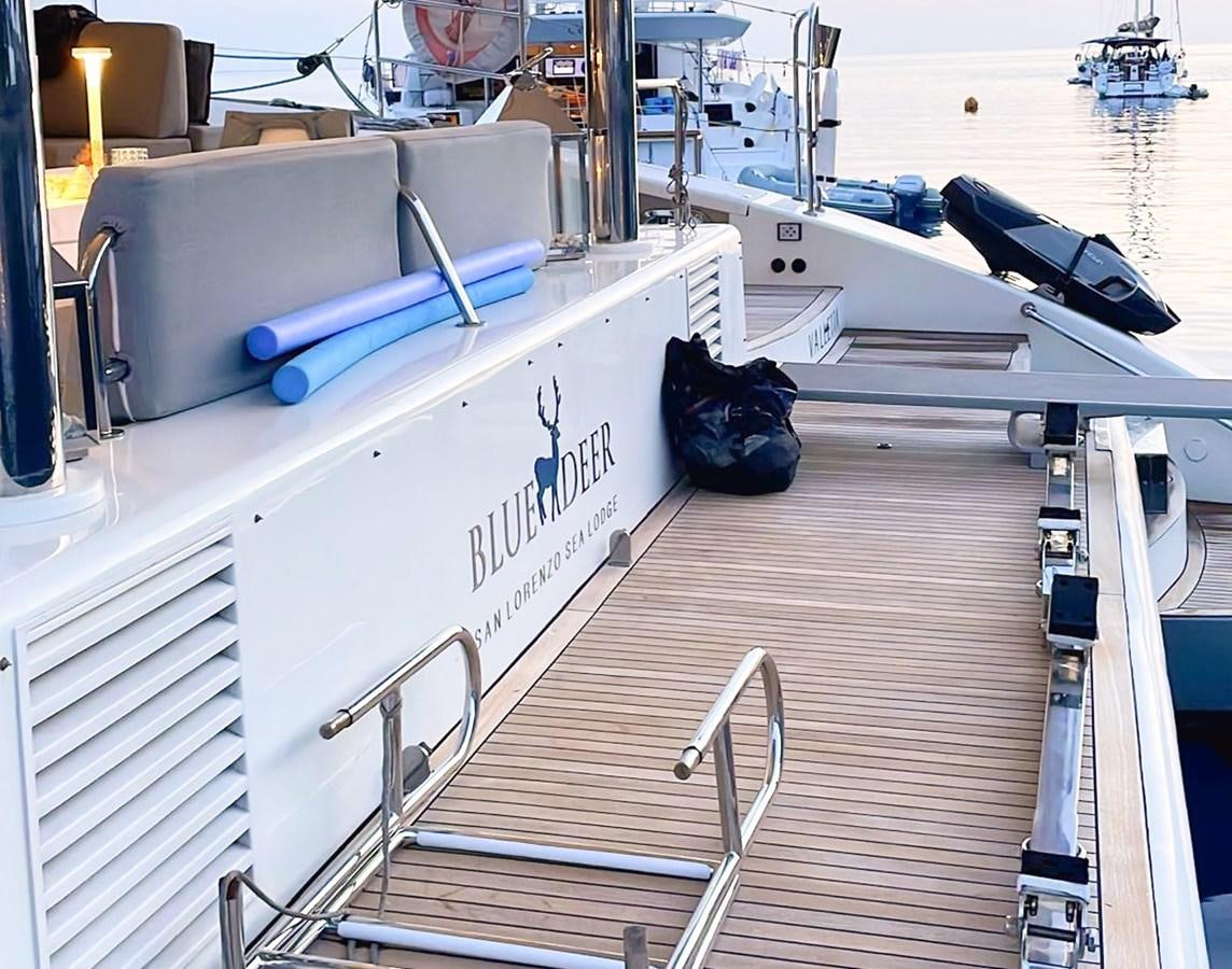 a white boat with a blue paddle on the deck aboard BLUE DEER Yacht for Sale