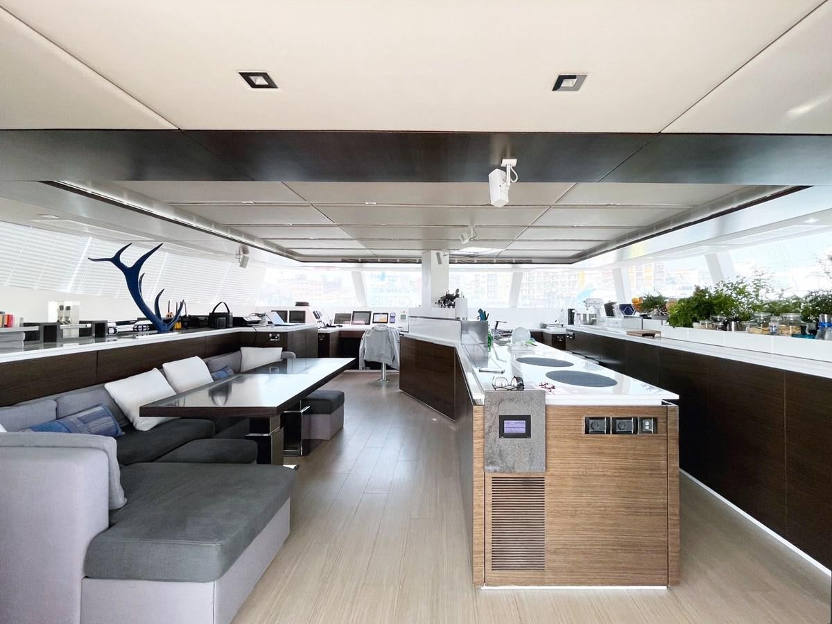 a room with a wood floor and couches aboard BLUE DEER Yacht for Sale