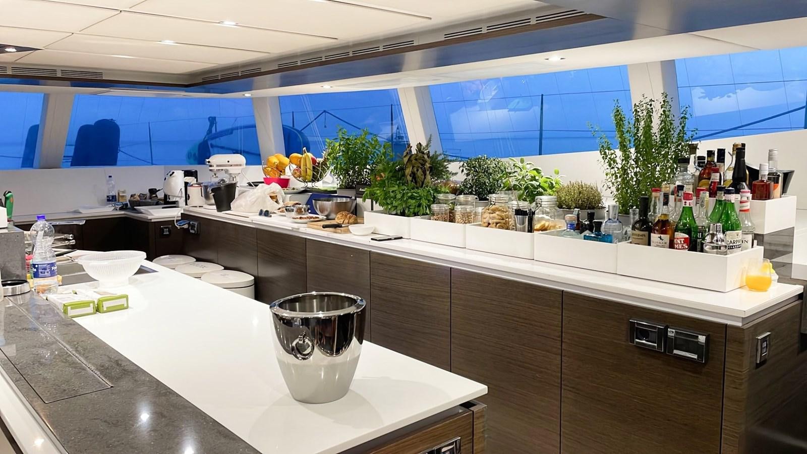 a kitchen with a glass cup on the counter aboard BLUE DEER Yacht for Sale