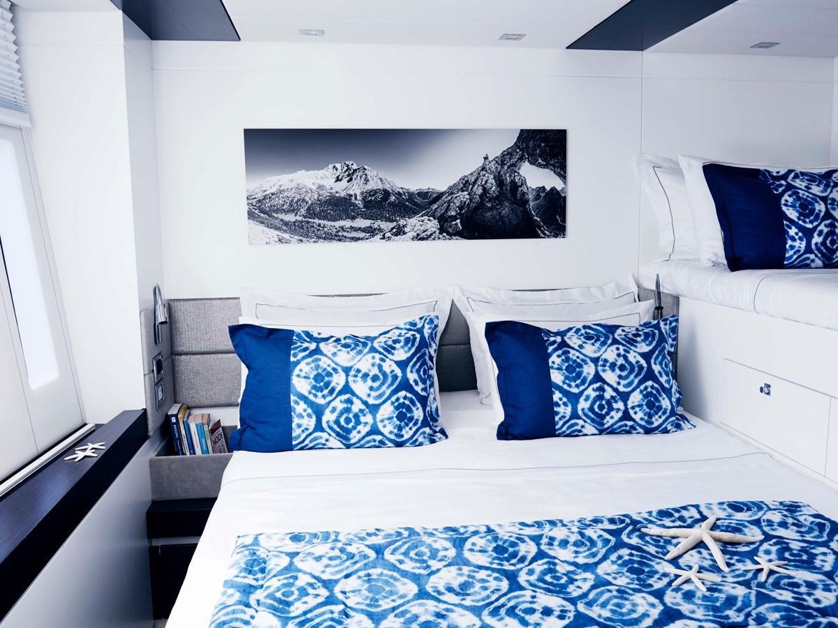 a bed with blue pillows aboard BLUE DEER Yacht for Sale