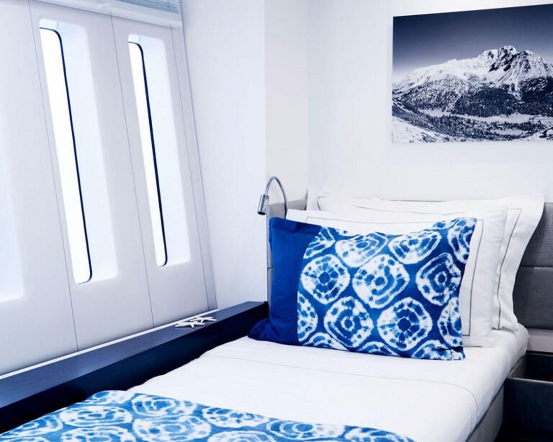a bed with a blue pillow aboard BLUE DEER Yacht for Sale