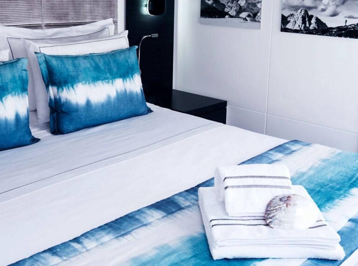 a bed with a blue pillow aboard BLUE DEER Yacht for Sale