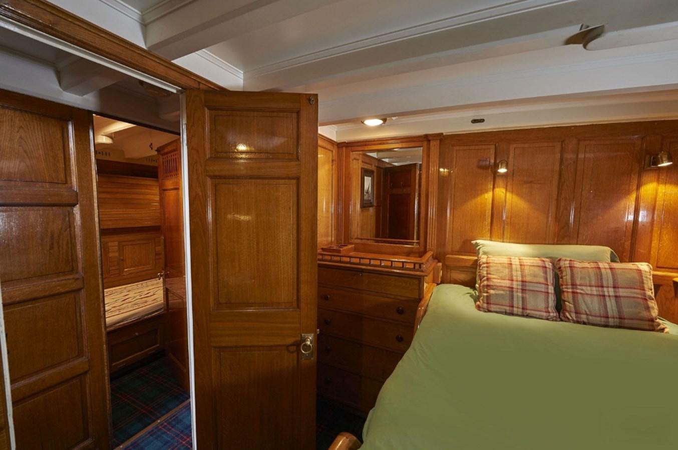a bedroom with a bed and a closet aboard SUMURUN Yacht for Sale