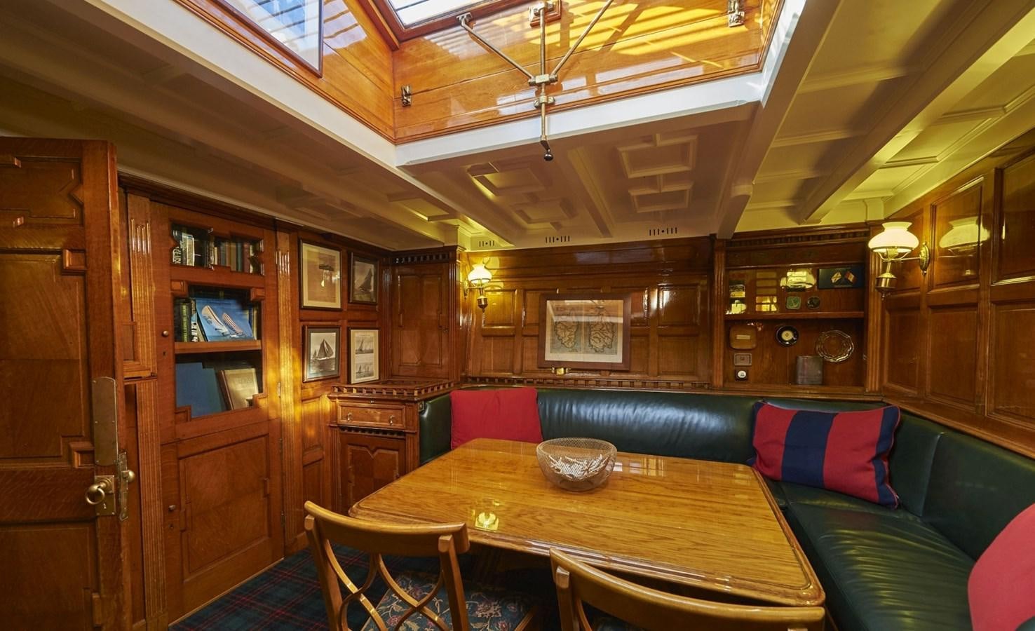 a room with a table and couch aboard SUMURUN Yacht for Sale