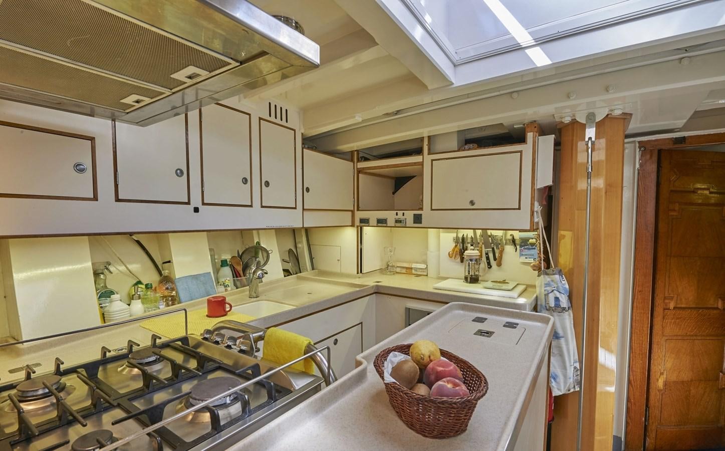 a kitchen with white cabinets aboard SUMURUN Yacht for Sale