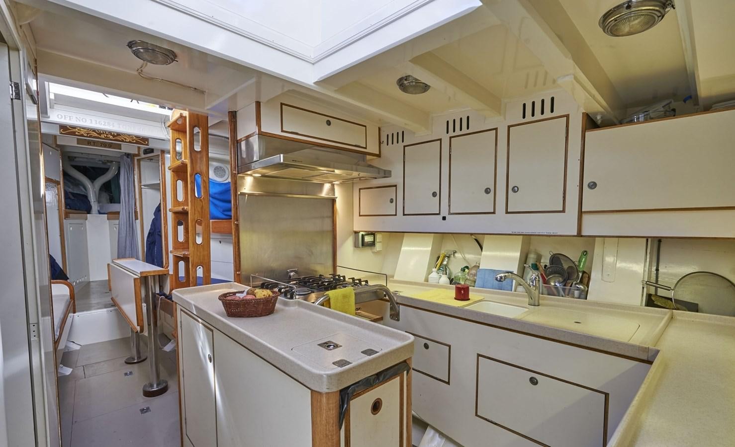 a kitchen with white cabinets aboard SUMURUN Yacht for Sale