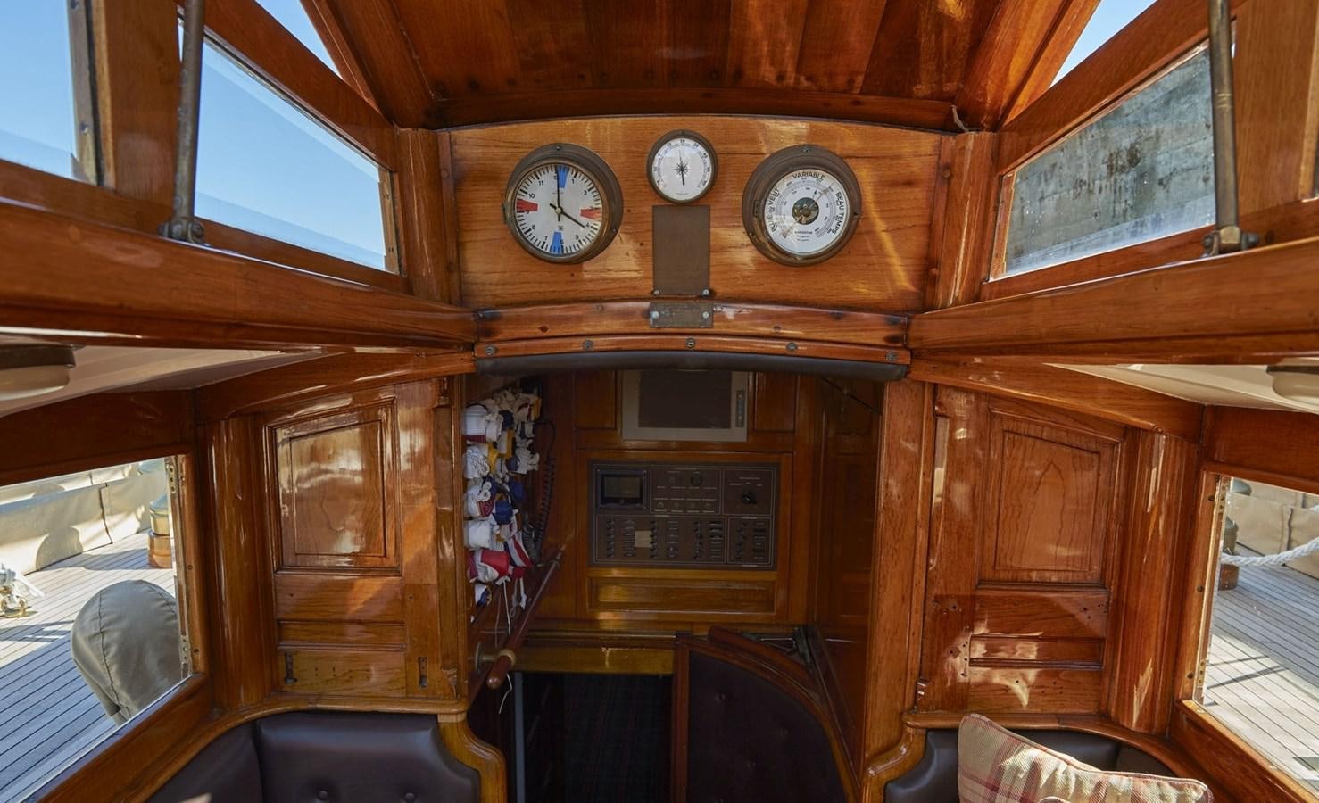 a clock on a wooden wall aboard SUMURUN Yacht for Sale