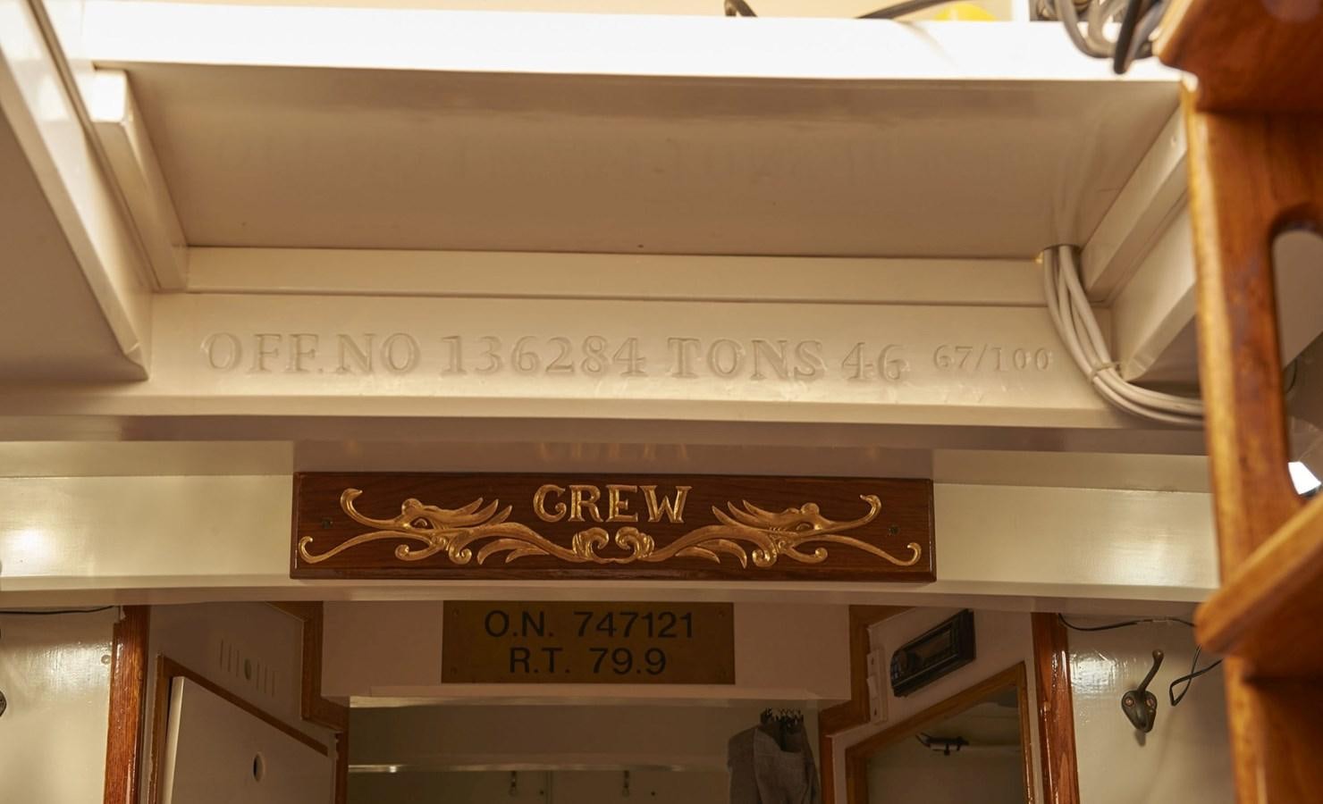 a white wooden shelf with a sign aboard SUMURUN Yacht for Sale