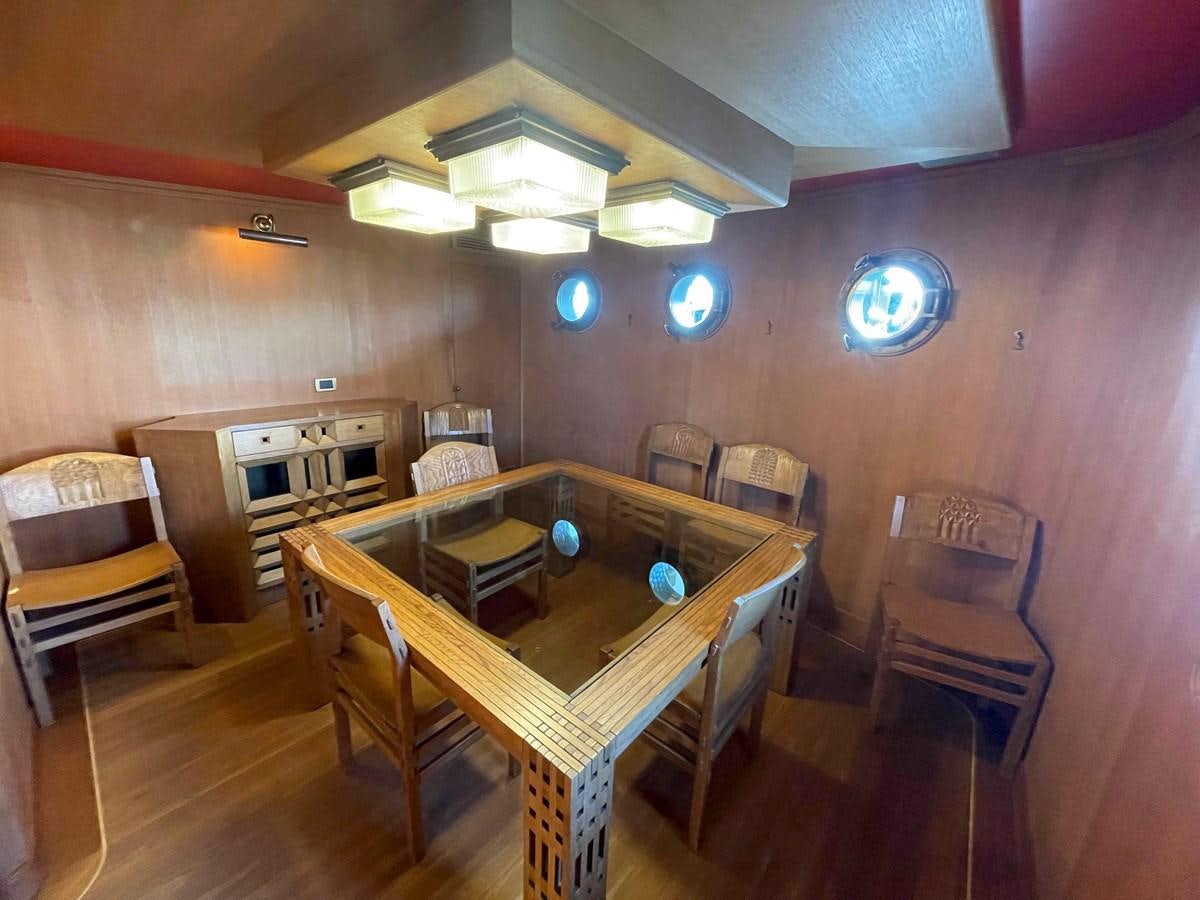 a room with a table and chairs aboard SAN GENNARO Yacht for Sale