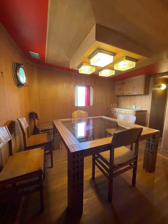 a kitchen with a table and chairs aboard SAN GENNARO Yacht for Sale