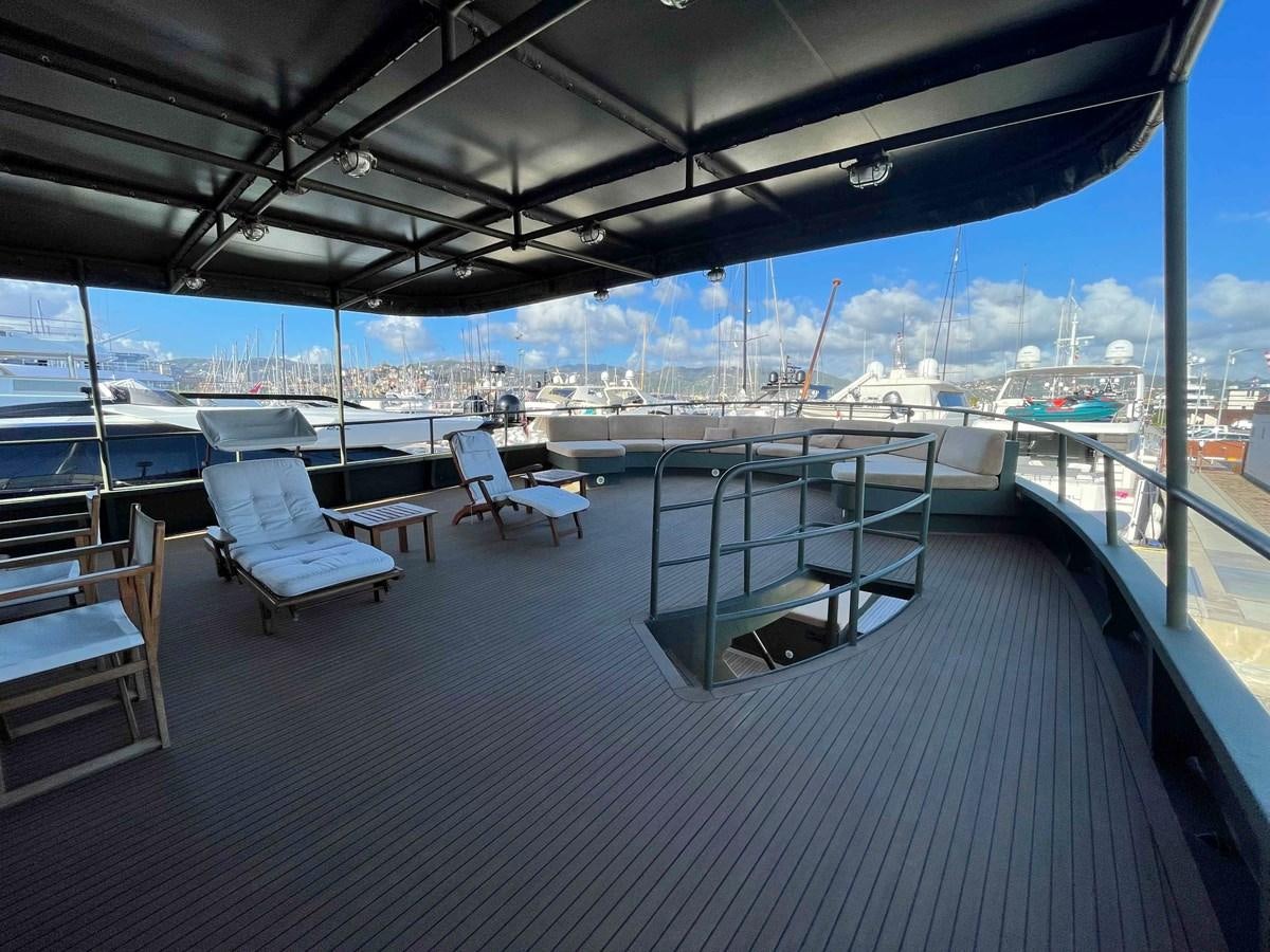a deck with a view of the water and boats aboard SAN GENNARO Yacht for Sale