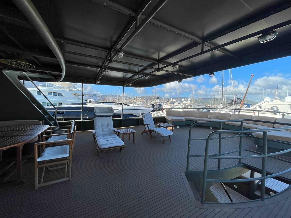 a deck with chairs and tables aboard SAN GENNARO Yacht for Sale