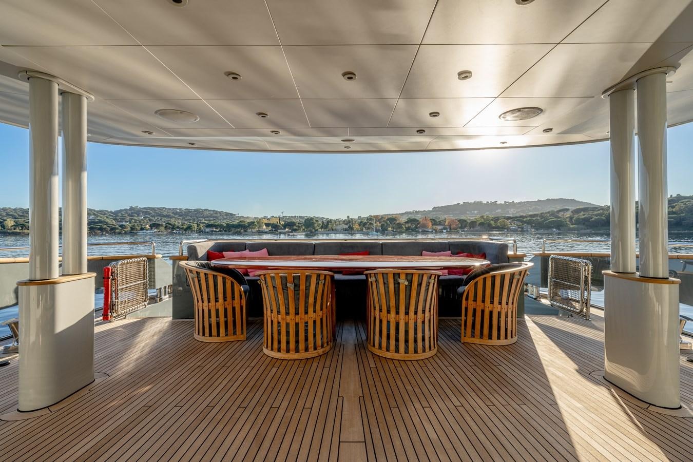 a table and chairs on a deck aboard ANNAMIA Yacht for Sale