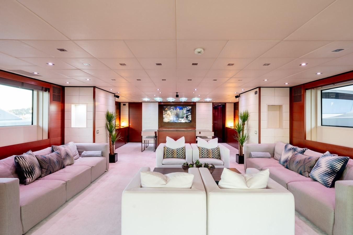 a living room with white couches aboard ANNAMIA Yacht for Sale