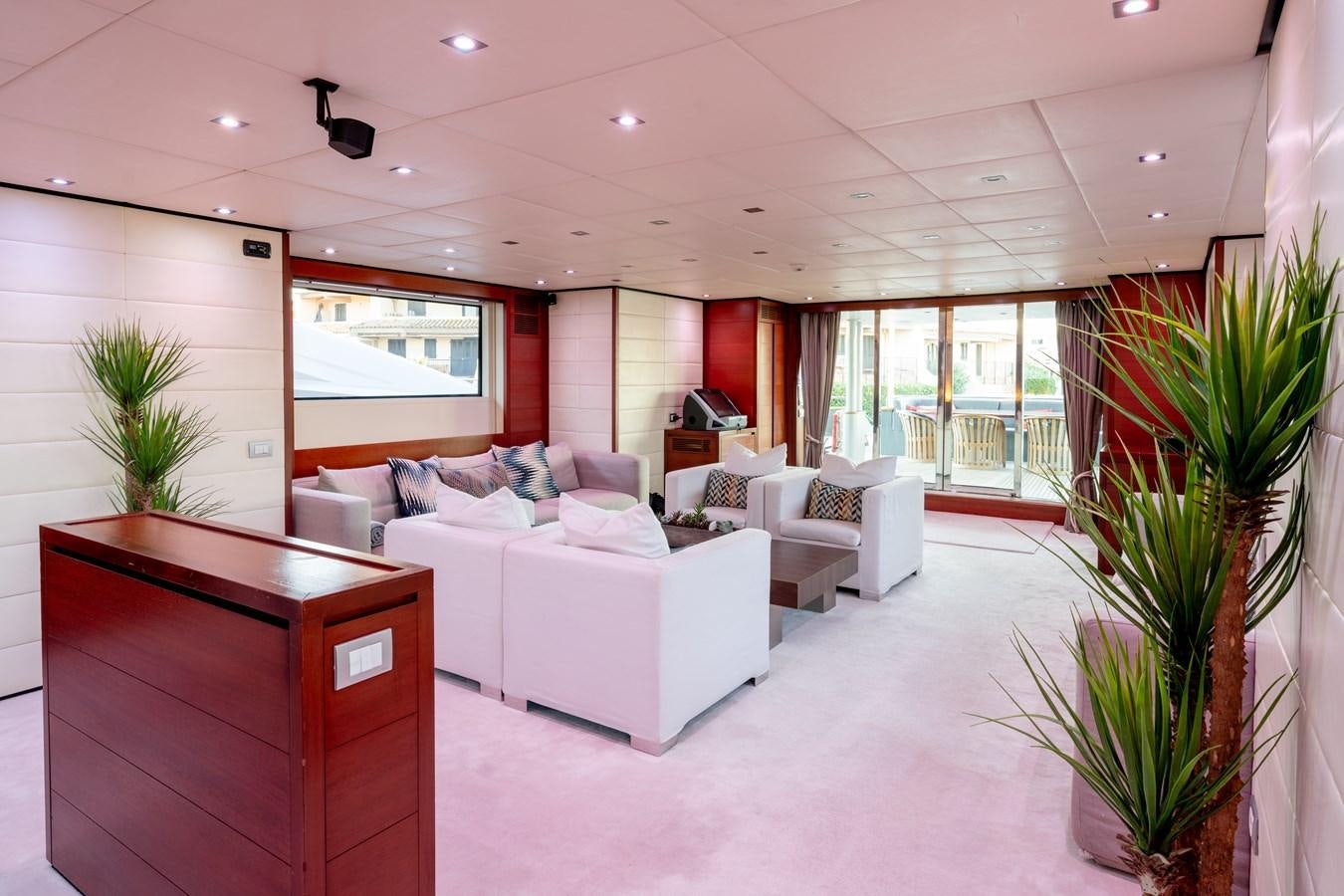 a living room with a white couch and a white sofa aboard ANNAMIA Yacht for Sale