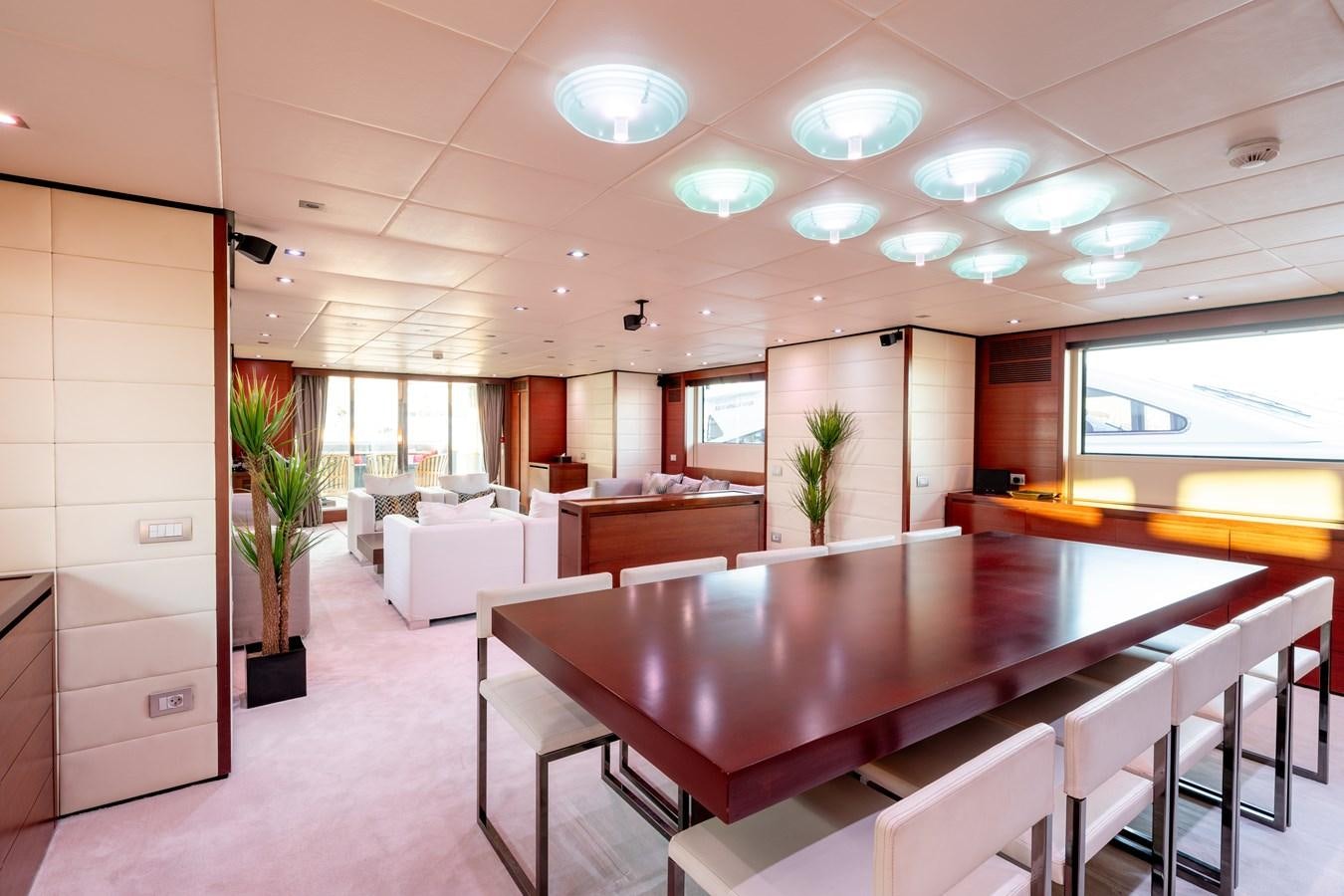 a large room with a table and chairs aboard ANNAMIA Yacht for Sale