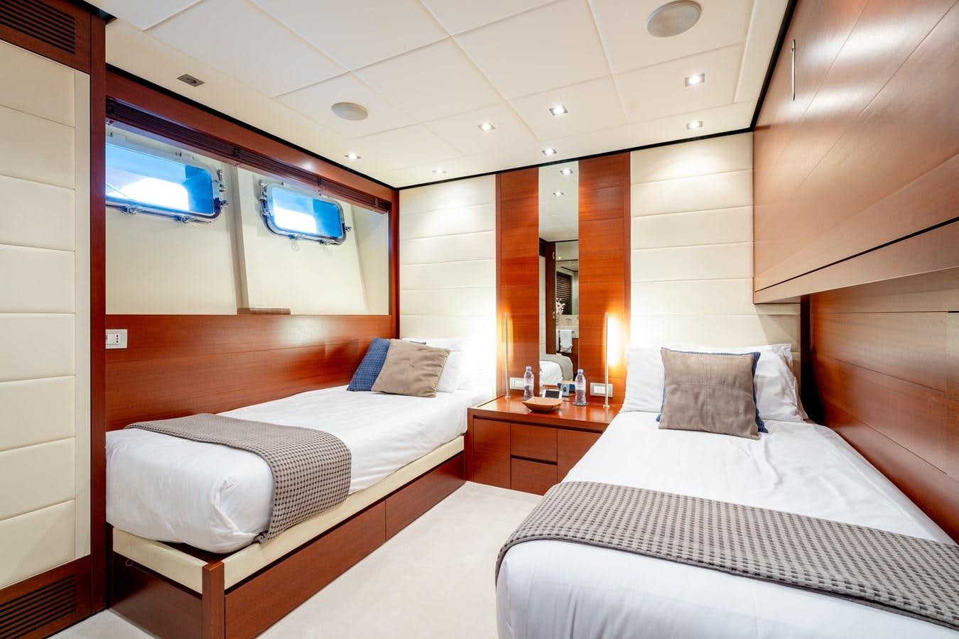 a room with beds and a window aboard ANNAMIA Yacht for Sale