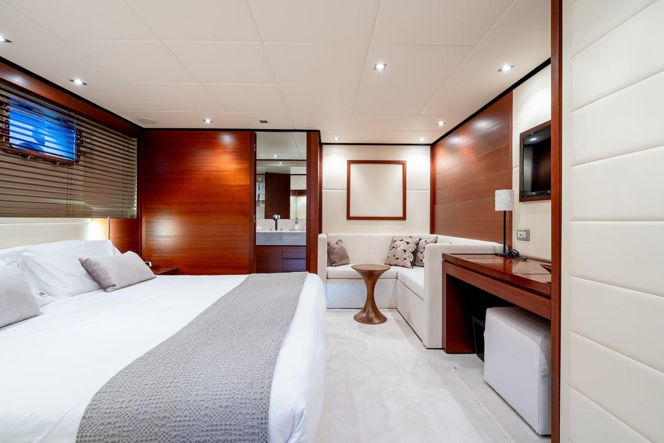 a room with a bed and a desk aboard ANNAMIA Yacht for Sale