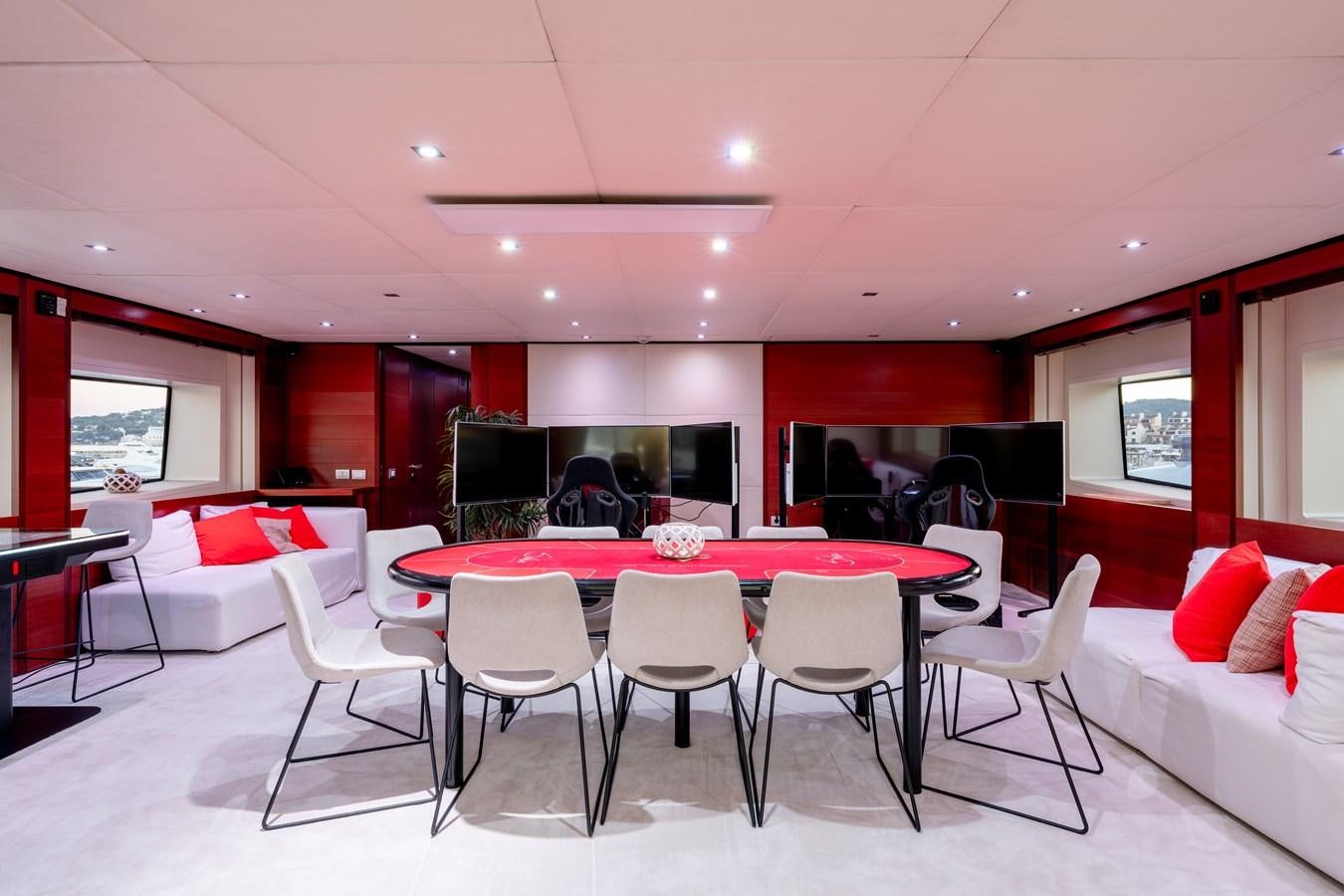 a room with tables and chairs aboard ANNAMIA Yacht for Sale