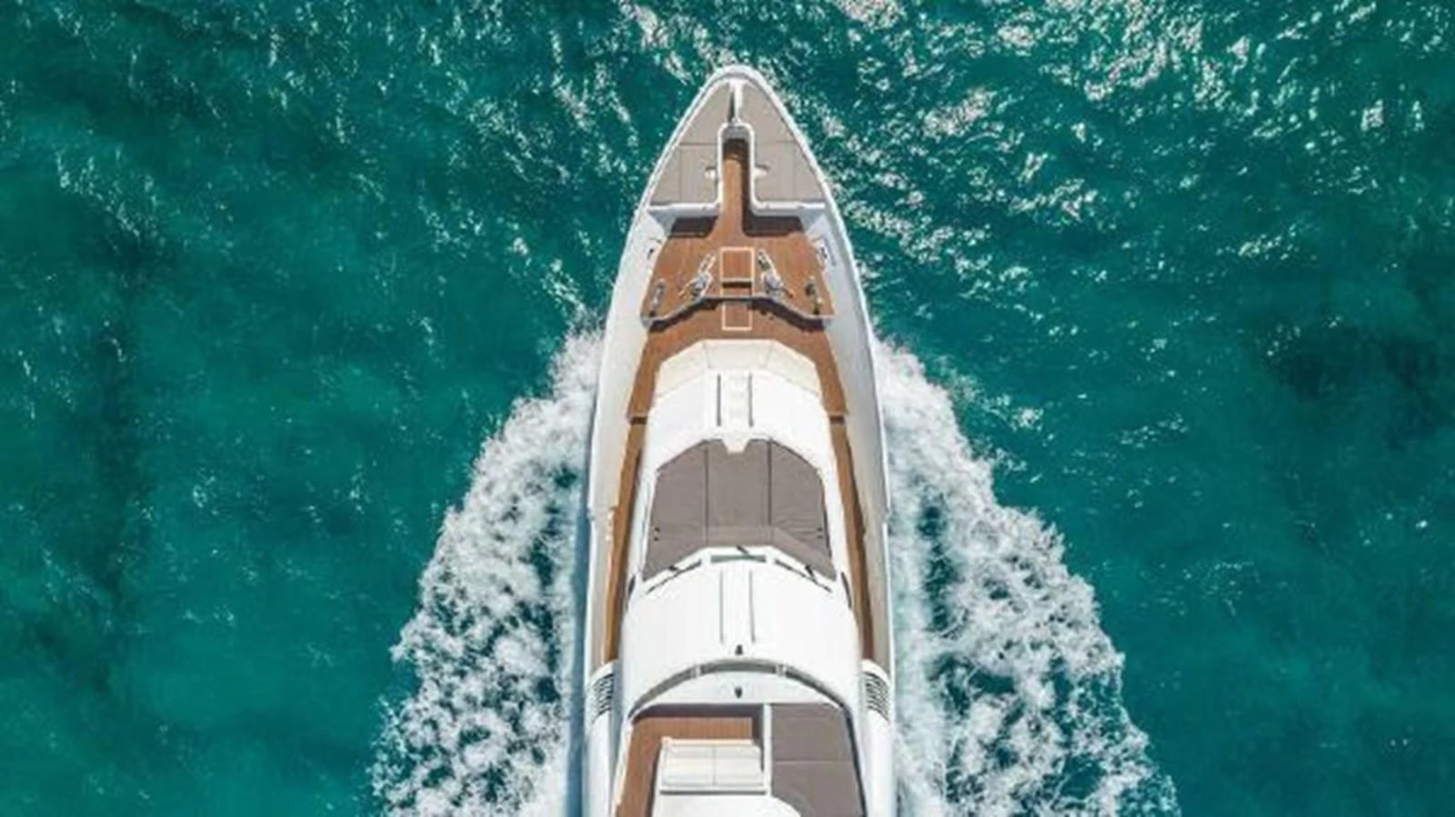 a tall building with trees around it aboard ROGUE Yacht for Sale