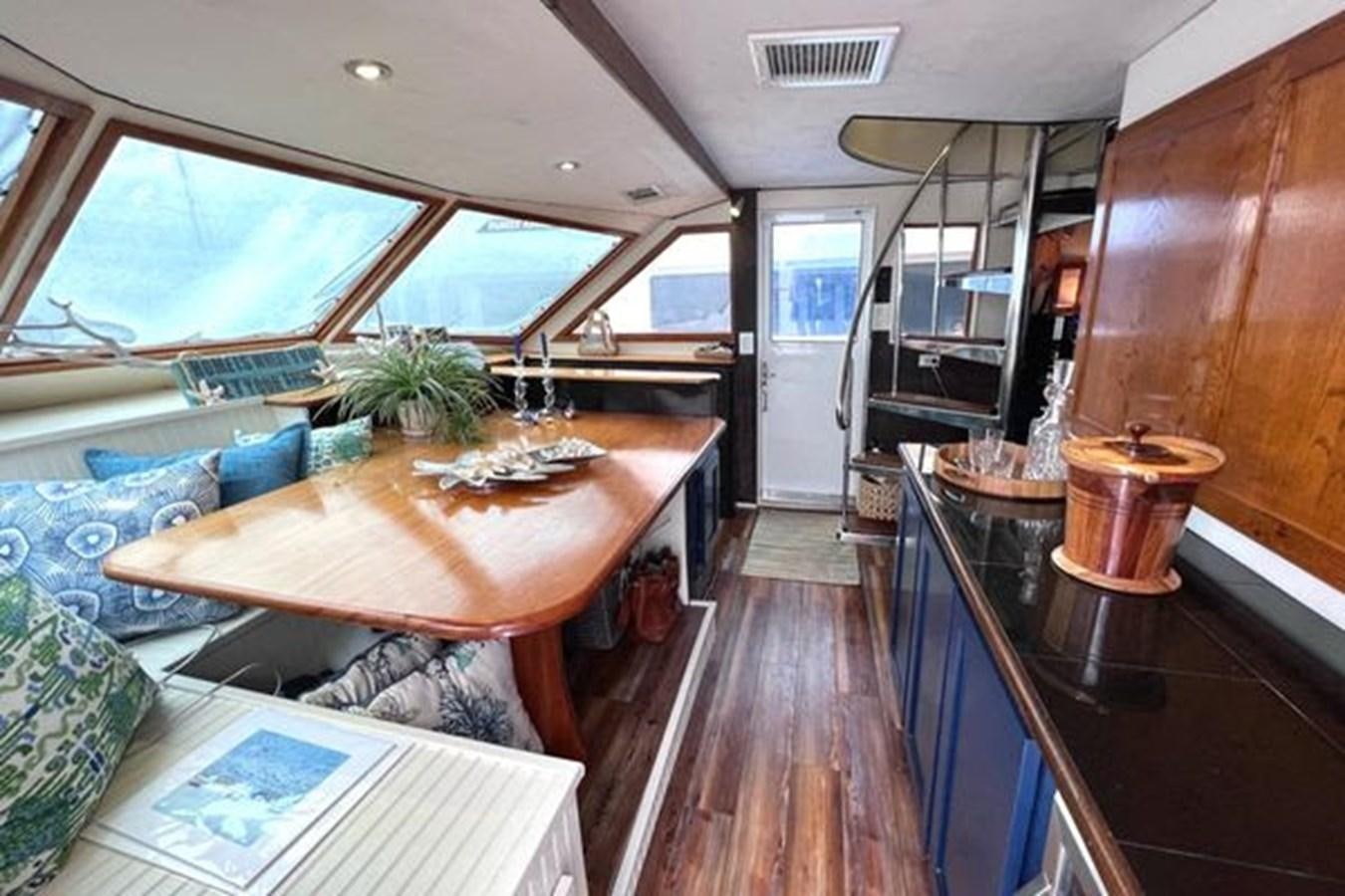 a kitchen with a table and a large window aboard NORTHER VENTURE Yacht for Sale