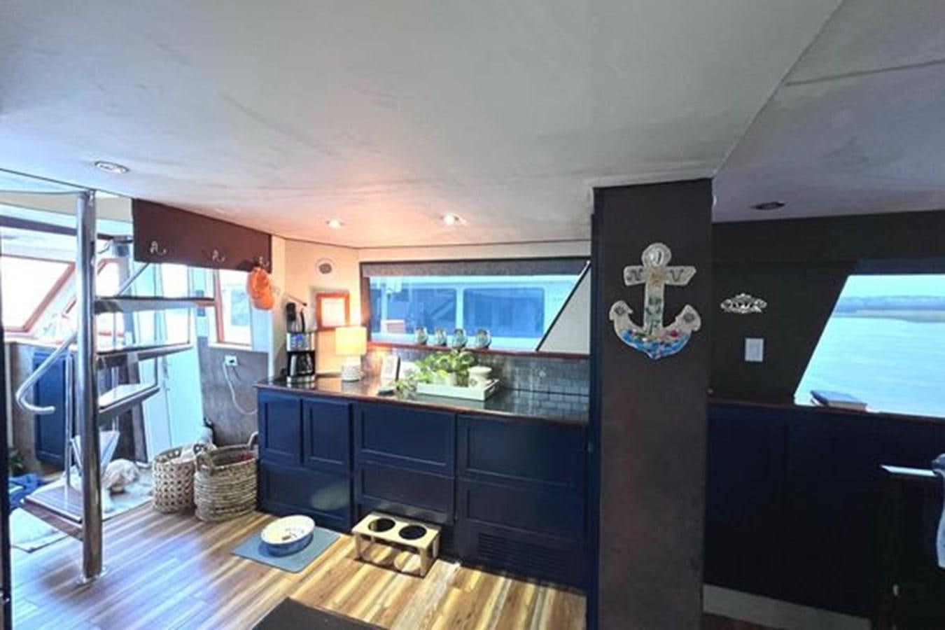 a kitchen with a wood floor aboard NORTHER VENTURE Yacht for Sale