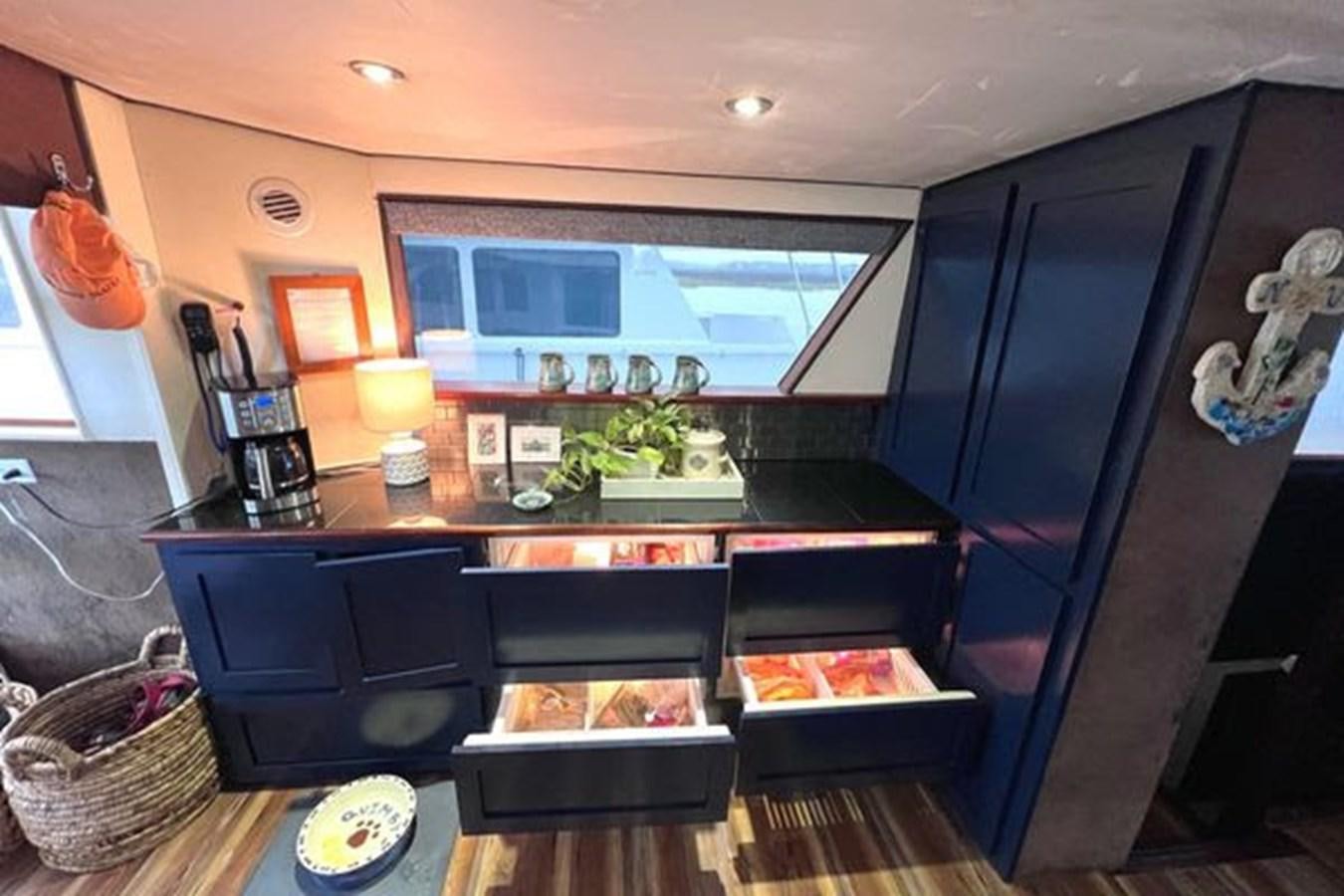 a kitchen with a black cabinet aboard NORTHER VENTURE Yacht for Sale