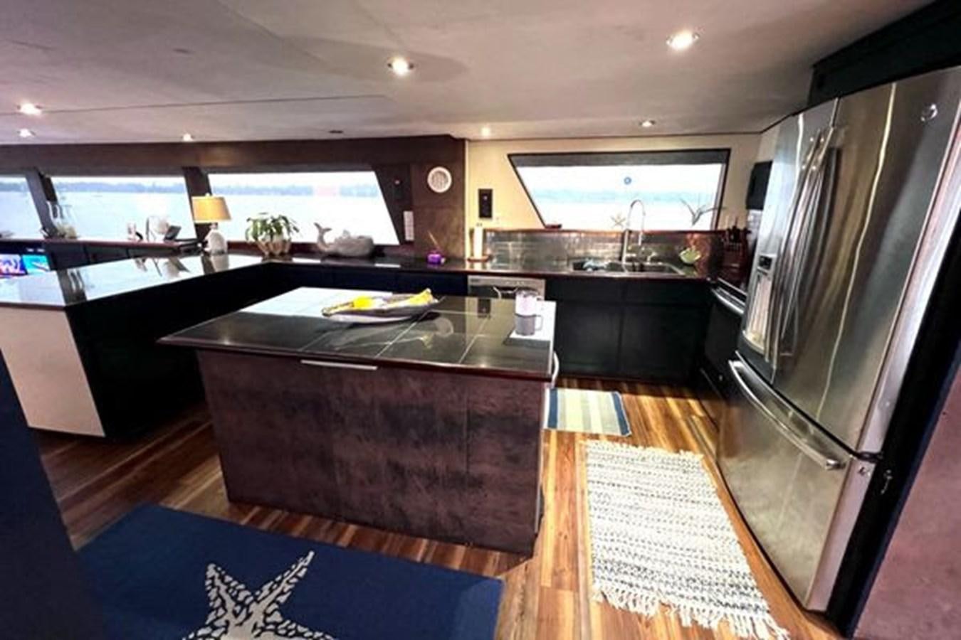 a kitchen with a large island aboard NORTHER VENTURE Yacht for Sale