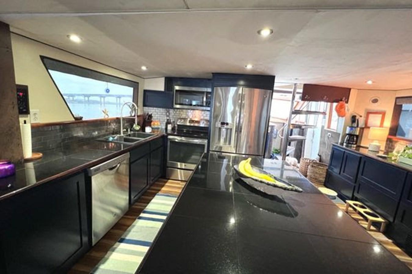 a kitchen with a large island aboard NORTHER VENTURE Yacht for Sale