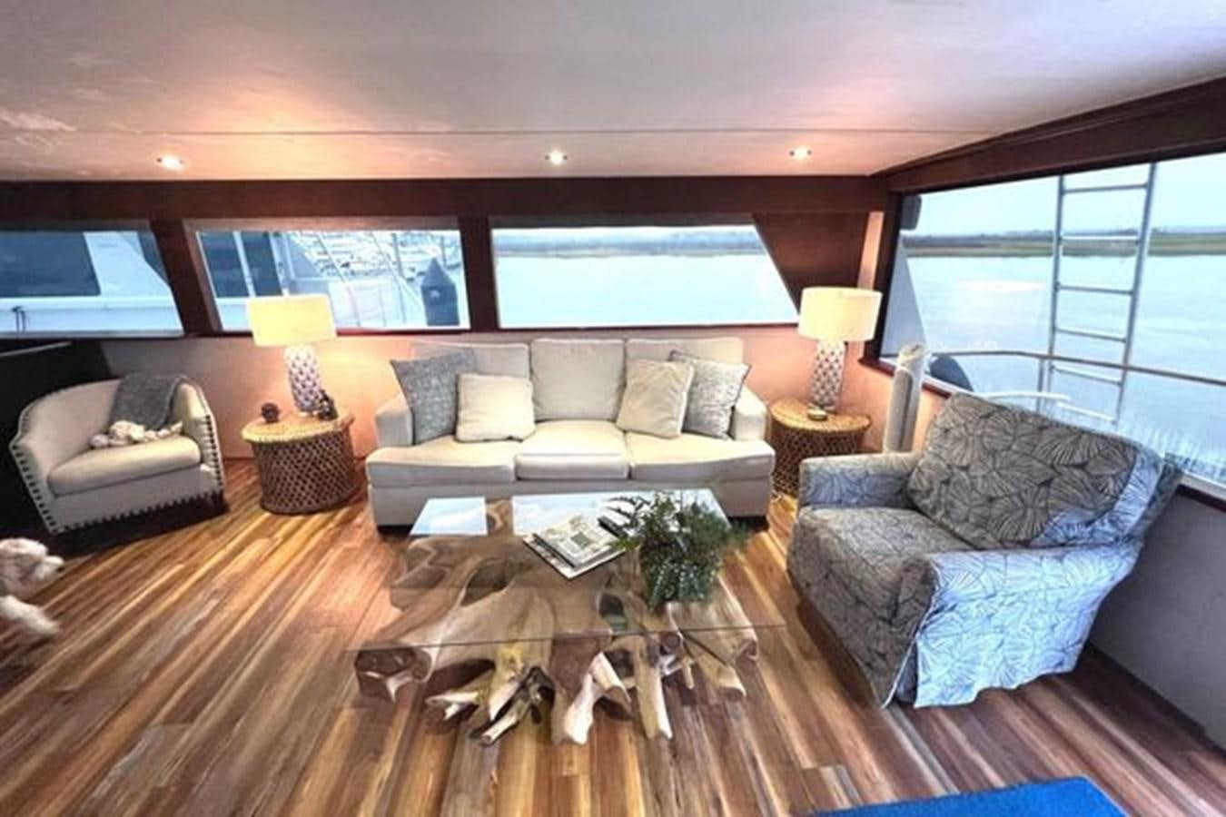a living room with a couch and a table aboard NORTHER VENTURE Yacht for Sale