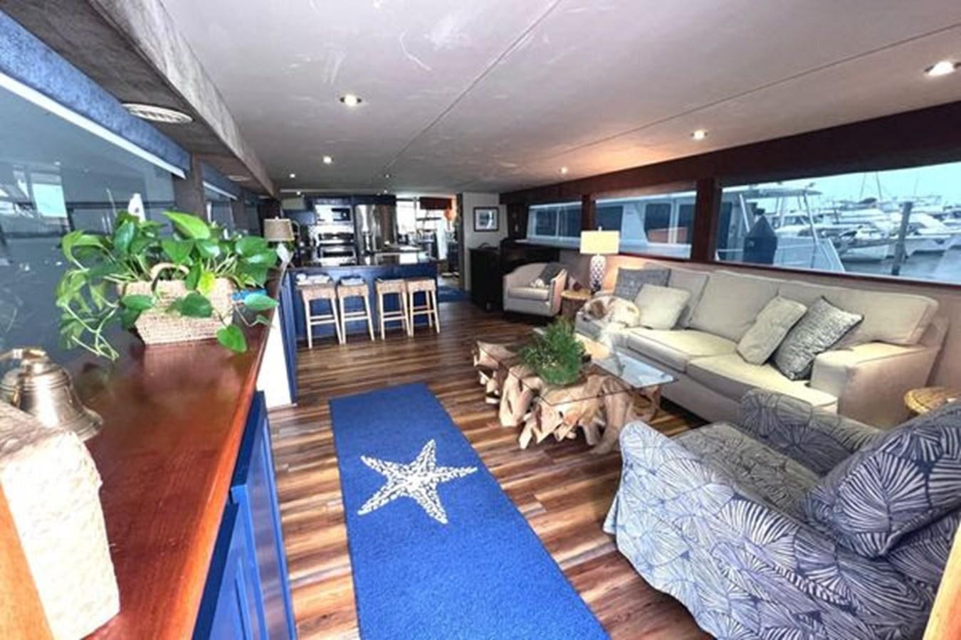 a living room with a large blue rug aboard NORTHER VENTURE Yacht for Sale
