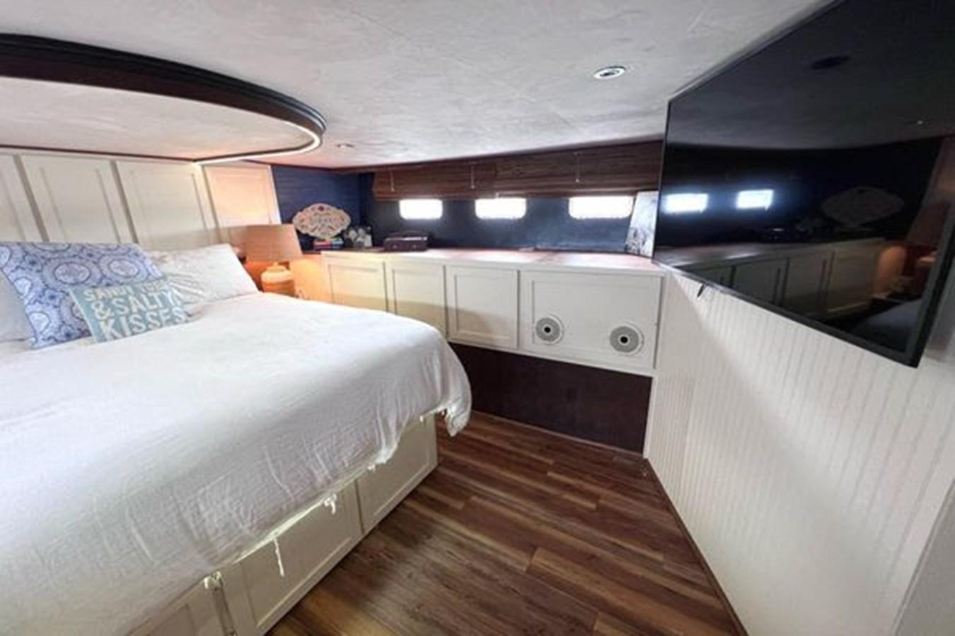 a room with a bed and a desk aboard NORTHER VENTURE Yacht for Sale