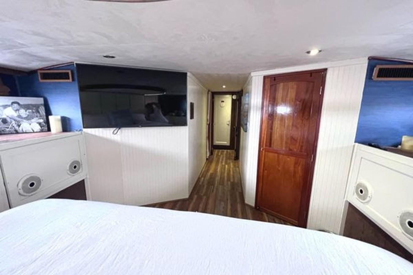 a room with a bed and a wood door aboard NORTHER VENTURE Yacht for Sale
