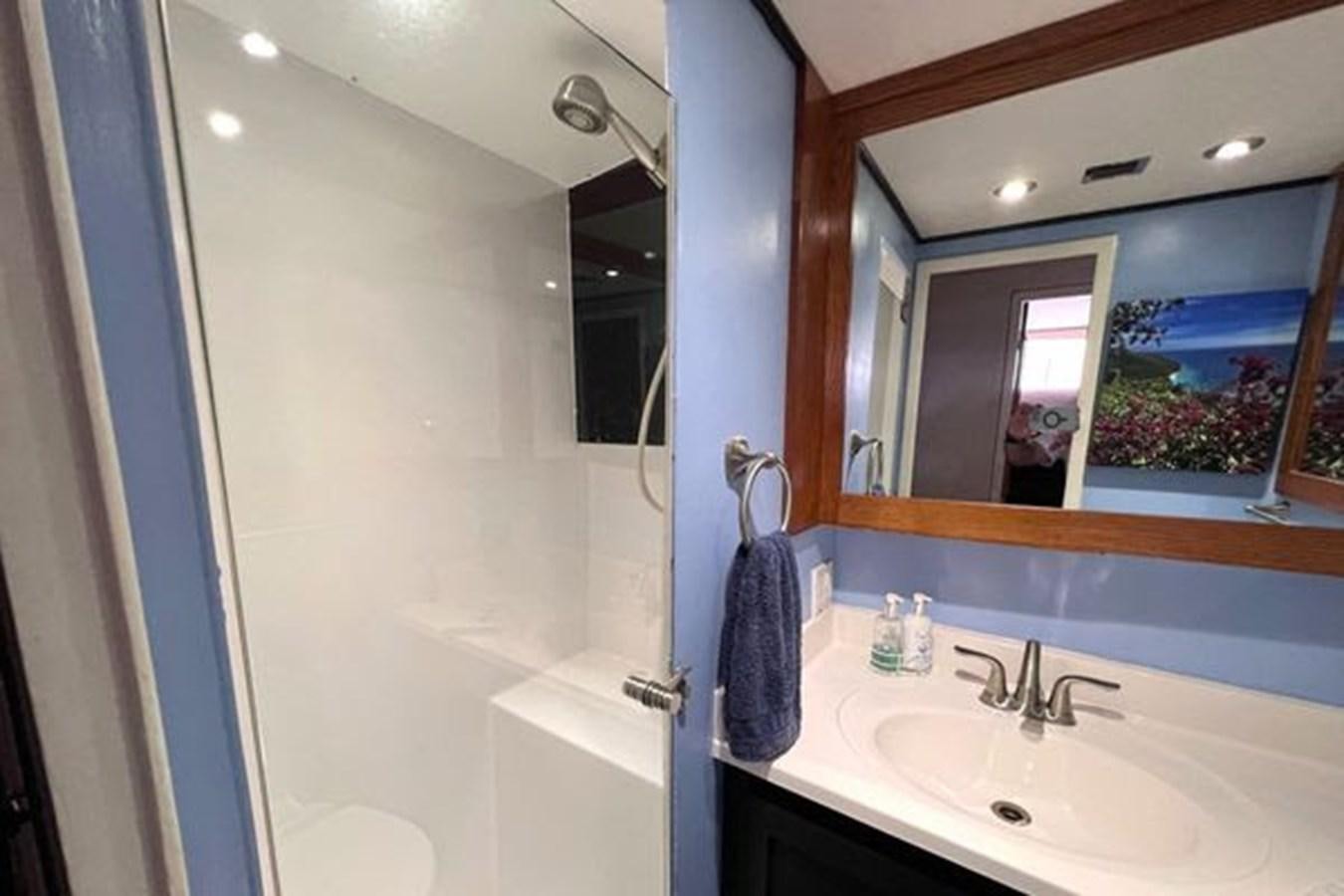 a bathroom with a large mirror aboard NORTHER VENTURE Yacht for Sale