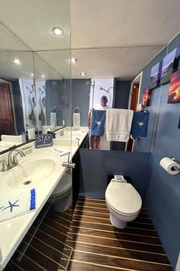 a bathroom with a sink toilet and a mirror aboard NORTHER VENTURE Yacht for Sale