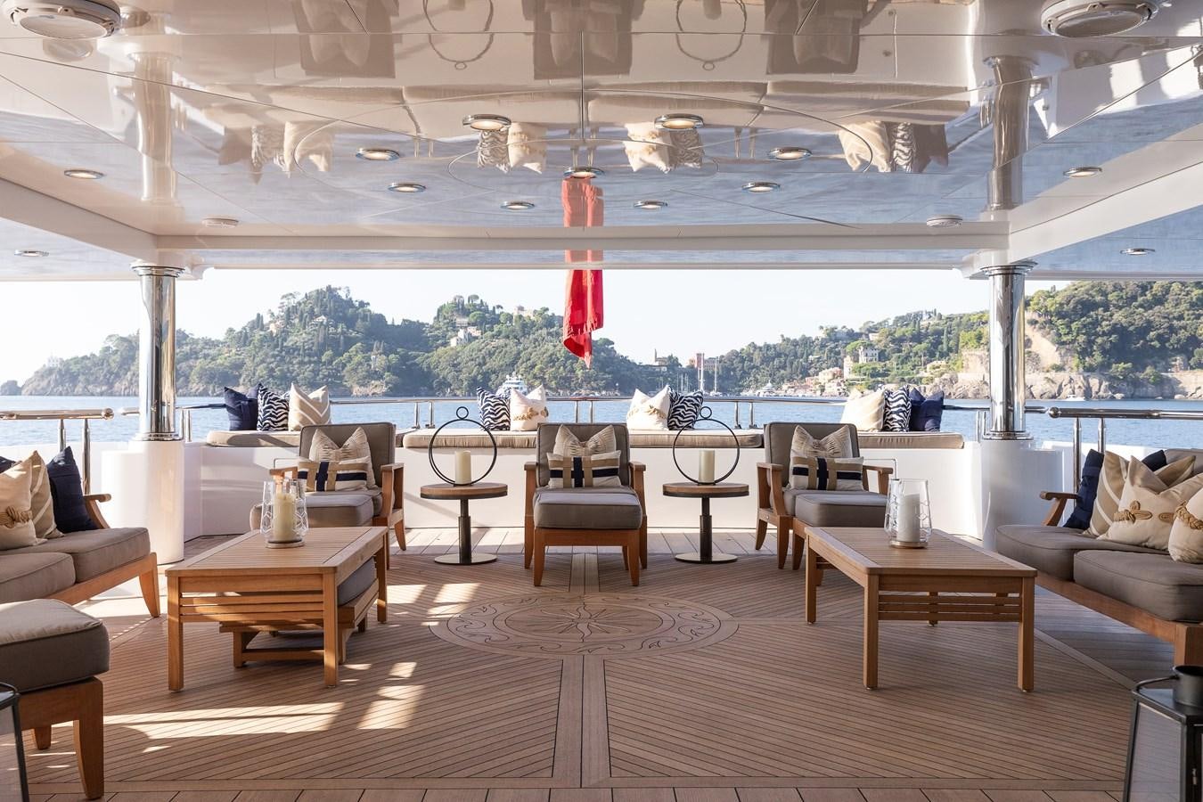 a room with tables and chairs aboard SKYFALL Yacht for Sale