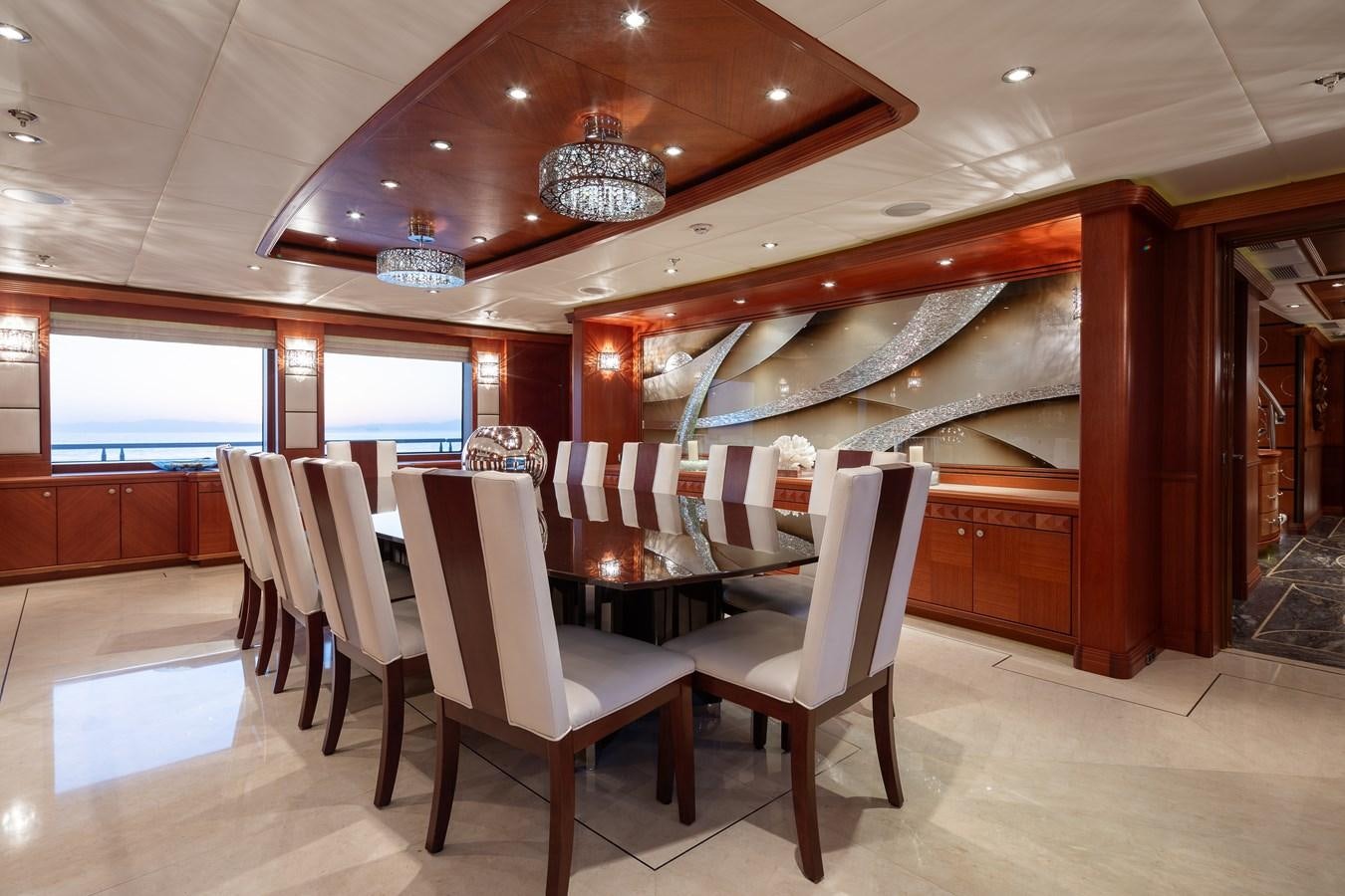 a room with chairs and a chandelier aboard SKYFALL Yacht for Sale