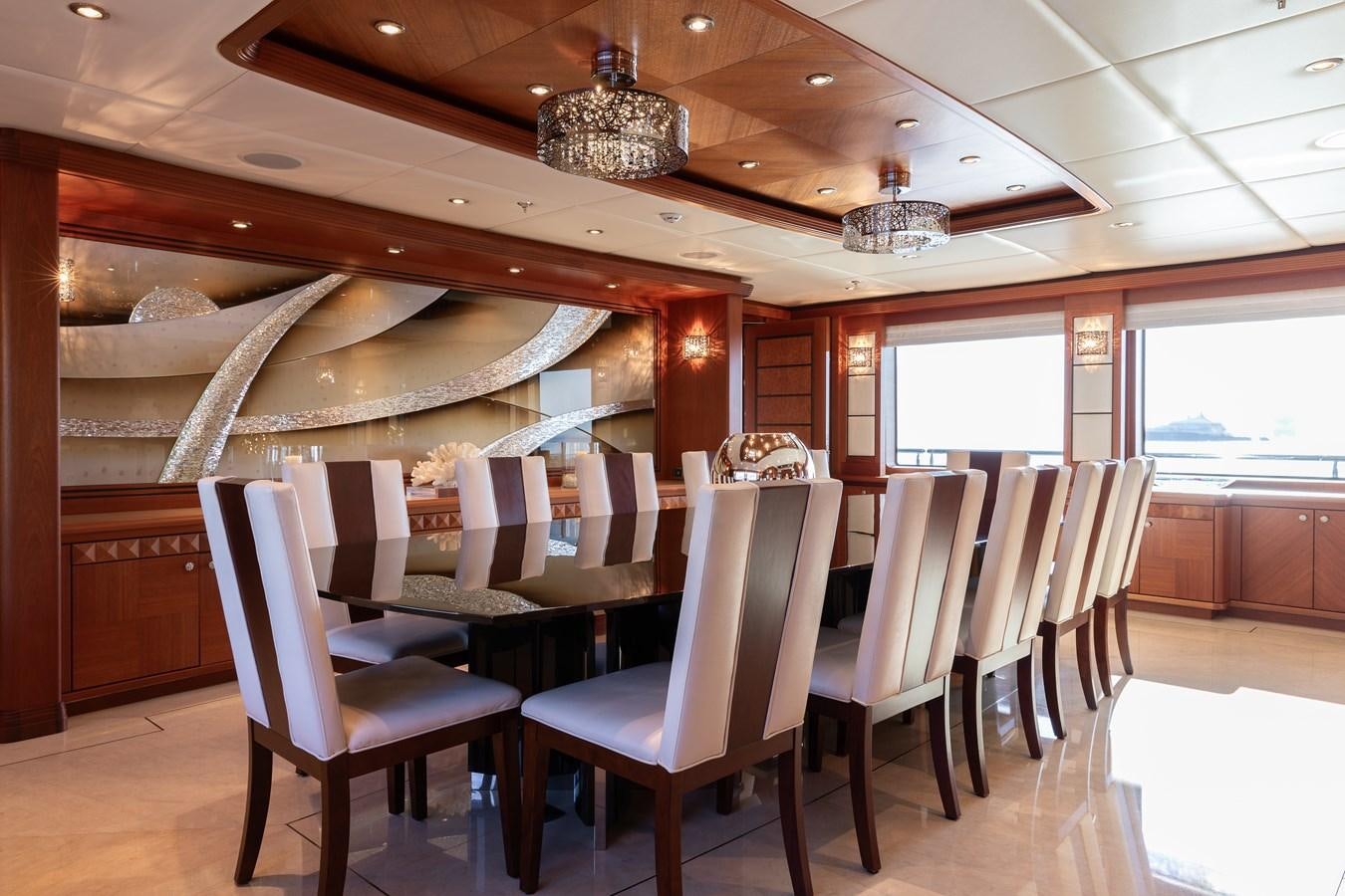 a room with chairs and a table aboard SKYFALL Yacht for Sale