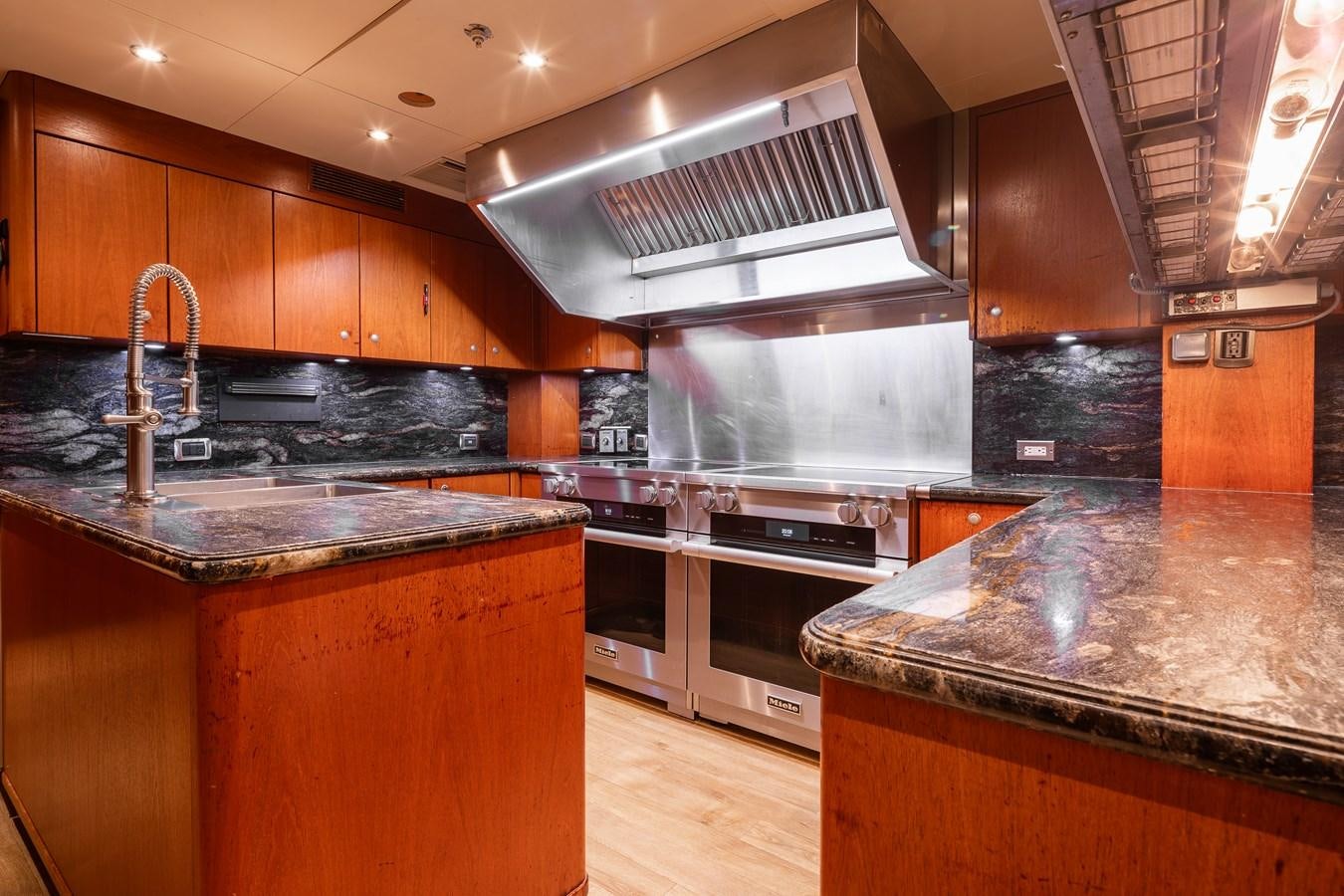 a kitchen with a stainless steel stove aboard SKYFALL Yacht for Sale