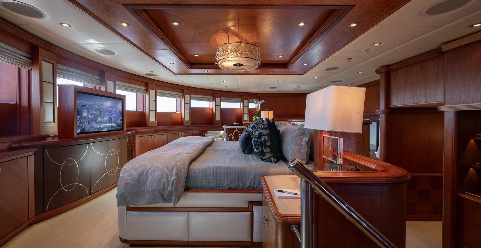 a room with a bed and a television aboard SKYFALL Yacht for Sale