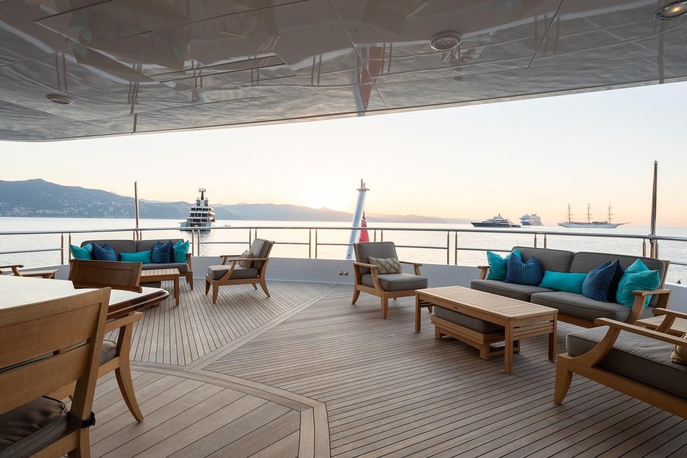 a room with a deck and chairs aboard SKYFALL Yacht for Sale