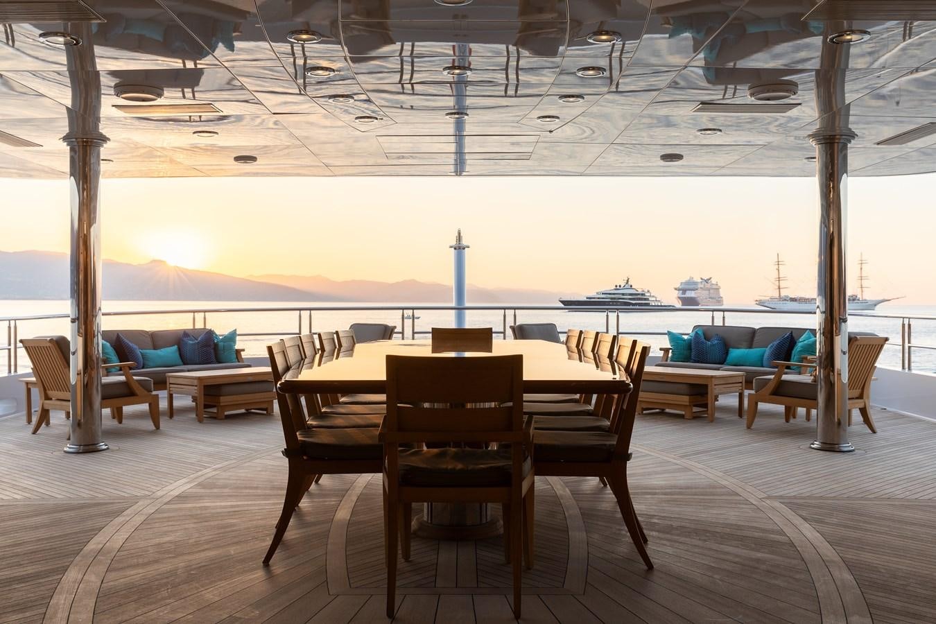 a table and chairs on a patio aboard SKYFALL Yacht for Sale