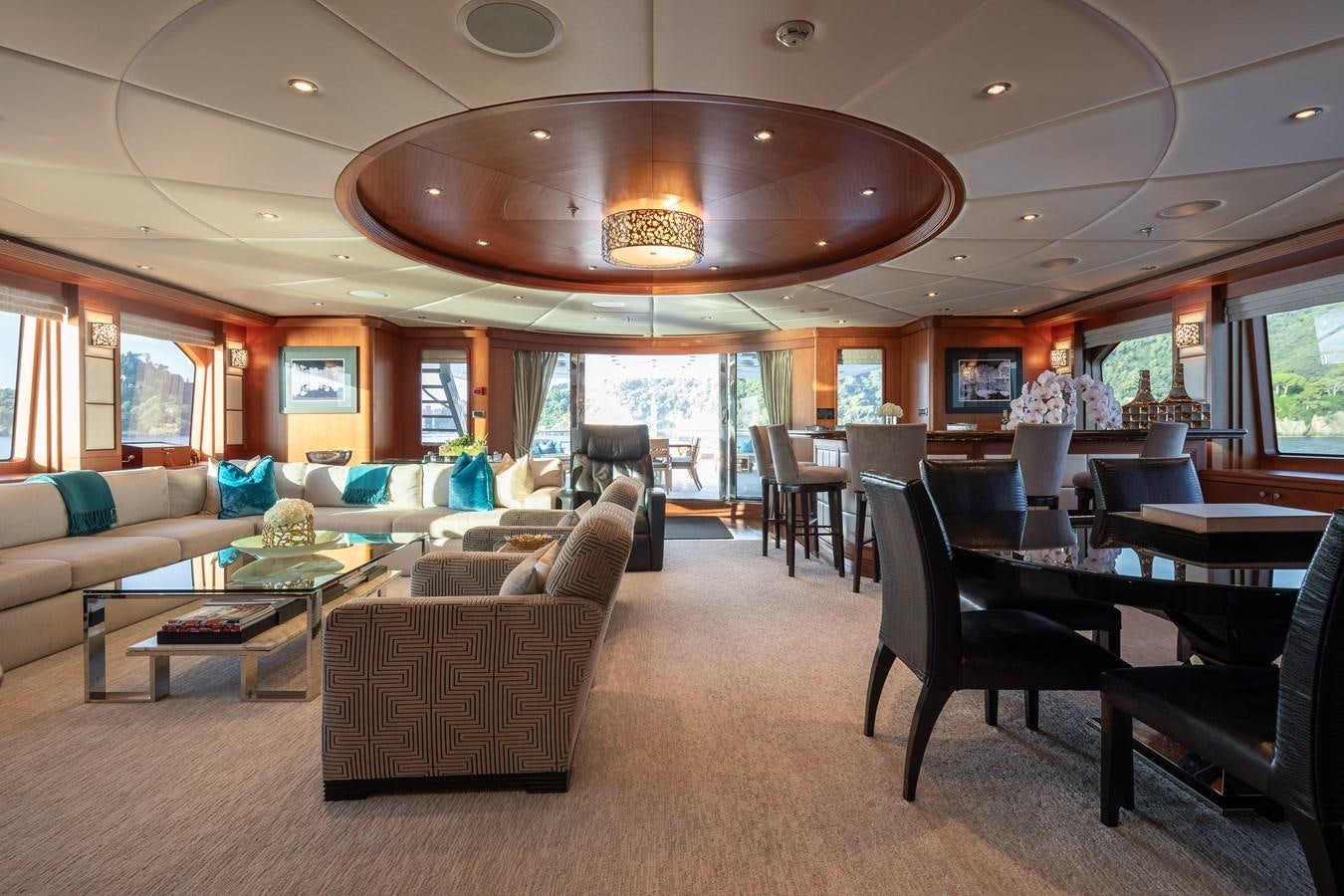 a large living room with a large chandelier aboard SKYFALL Yacht for Sale