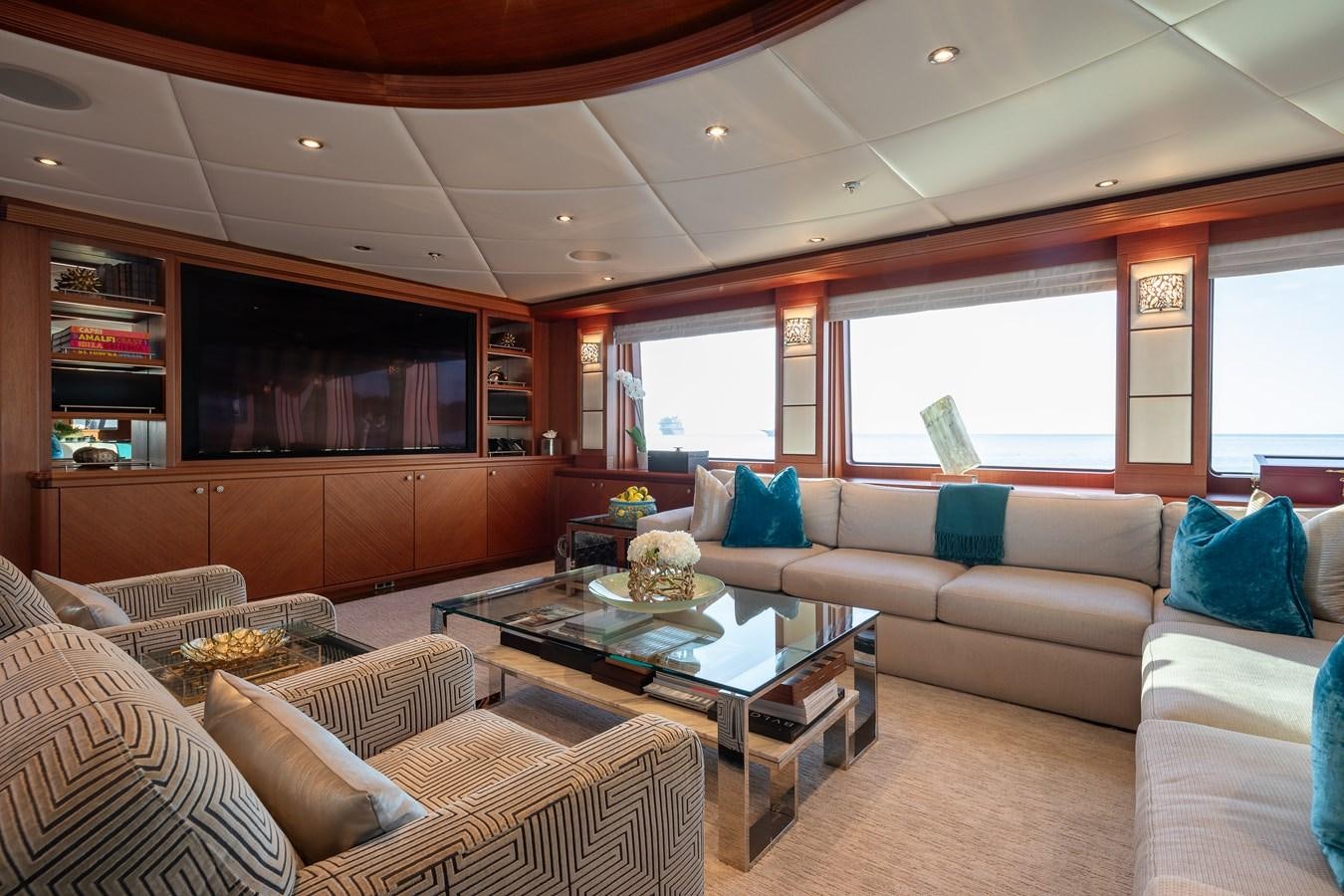 a living room with a couch and a coffee table aboard SKYFALL Yacht for Sale