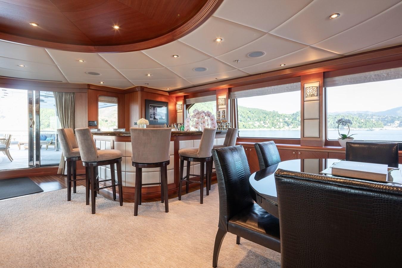 a room with a table chairs and a window aboard SKYFALL Yacht for Sale