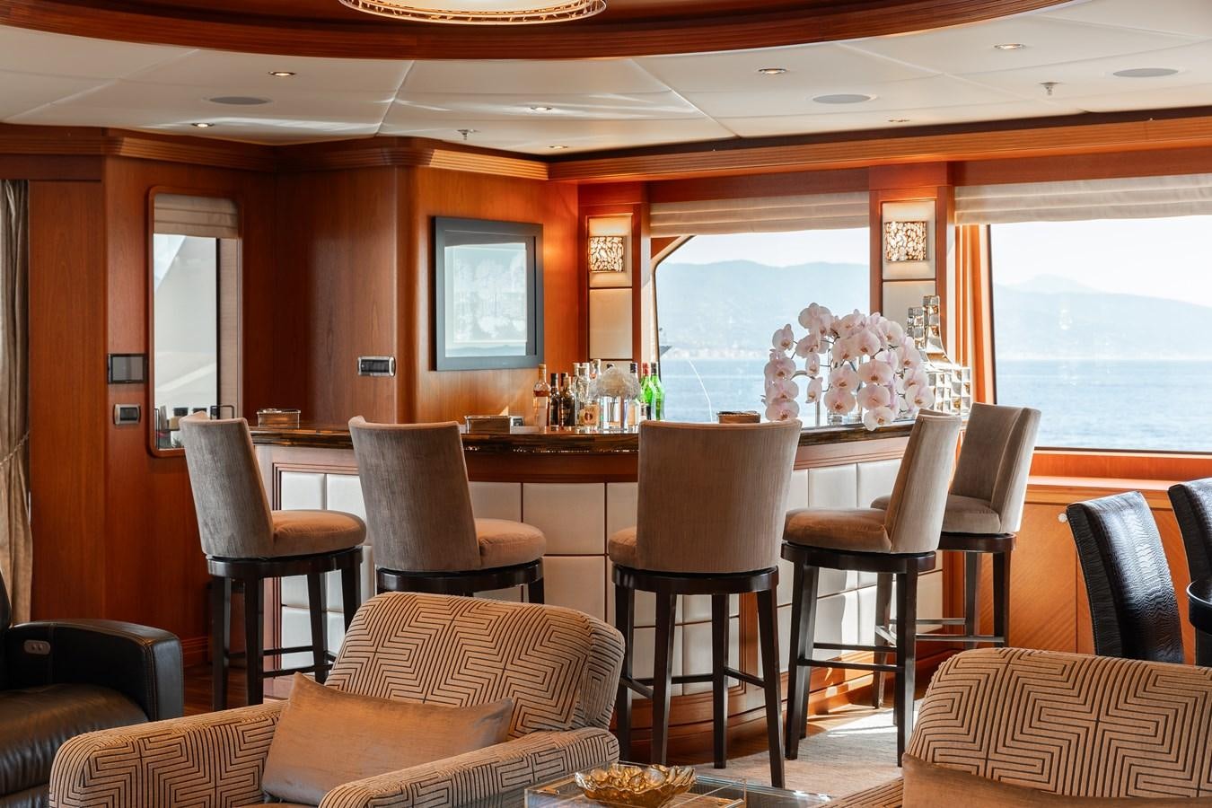 a dining room with a large window aboard SKYFALL Yacht for Sale