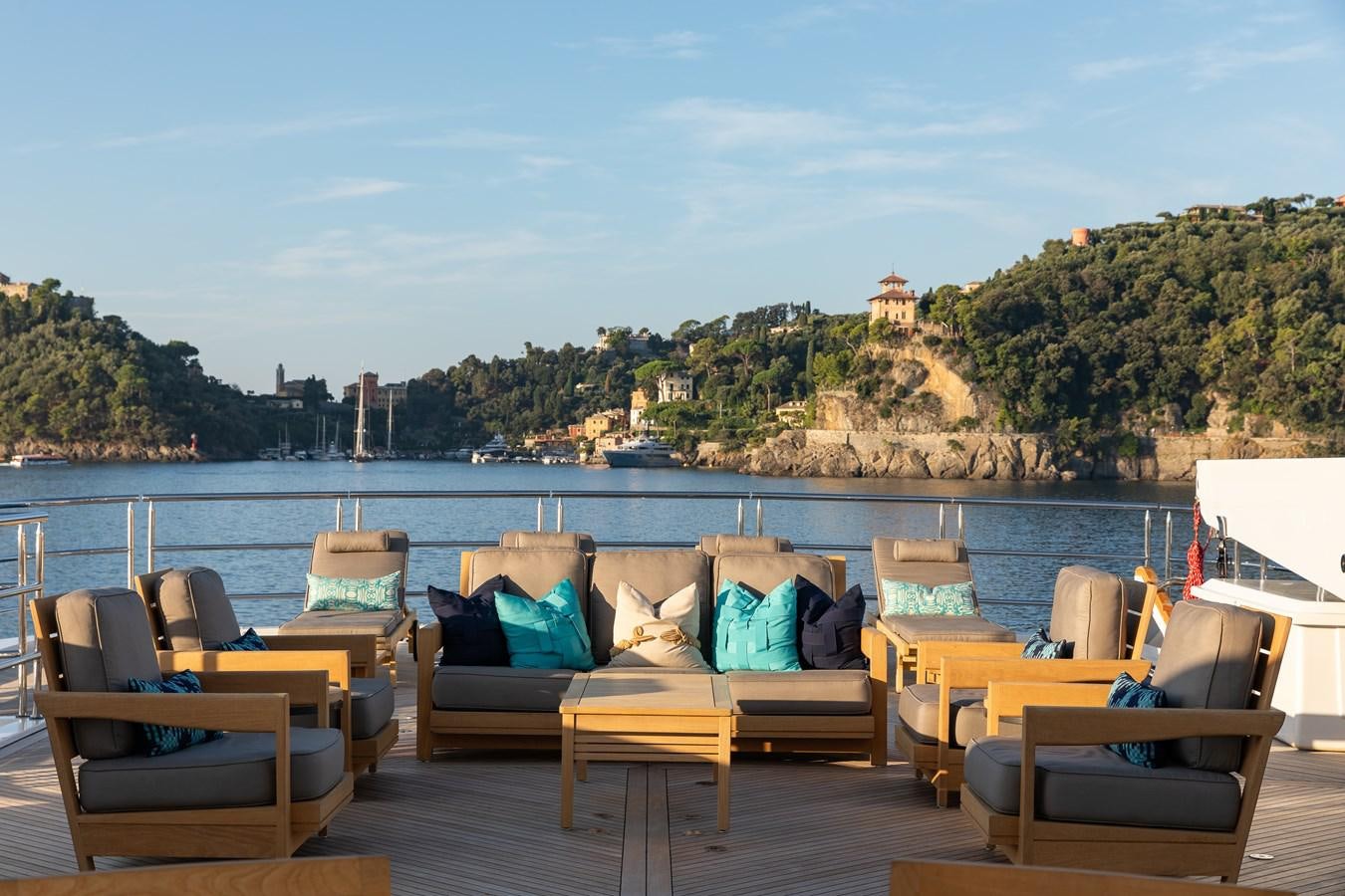 a deck with chairs and tables aboard SKYFALL Yacht for Sale