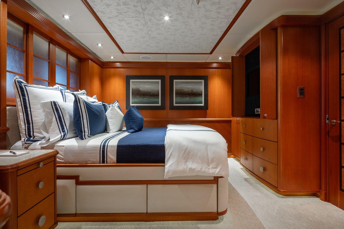 a room with a bed and a cabinet aboard SKYFALL Yacht for Sale