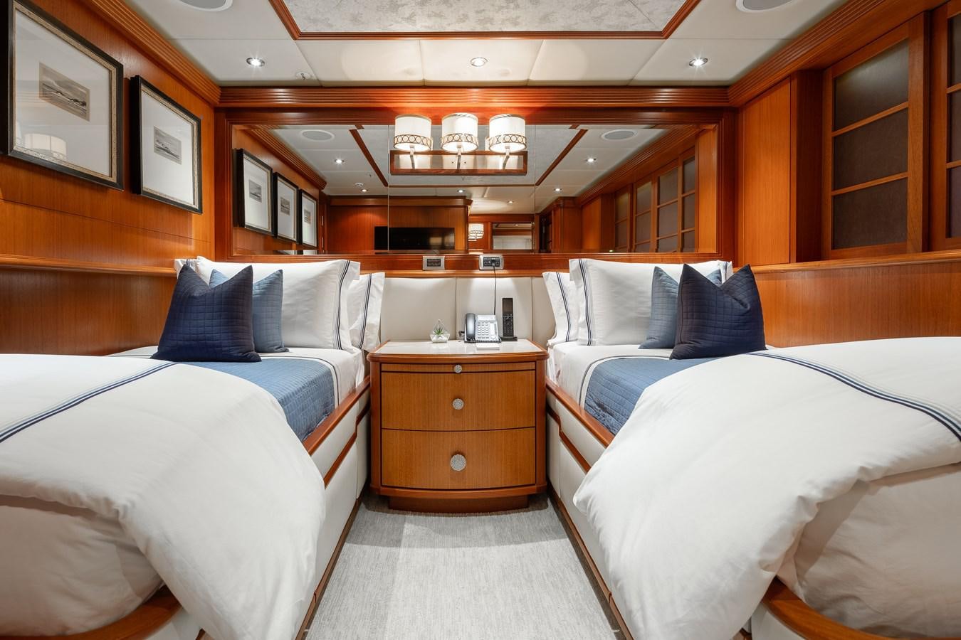 a room with beds and a dresser aboard SKYFALL Yacht for Sale