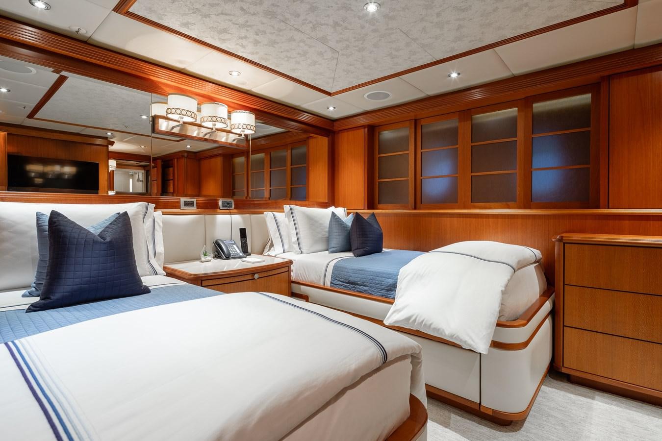 a room with a bed and a chair aboard SKYFALL Yacht for Sale